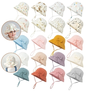 Macro shot showing diverse prints and colors of cotton baby sun hats with bow details