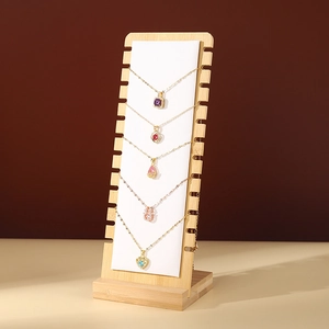 Bamboo wood necklace display stand with five colorful gemstone pendants in a row