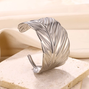 Detailed view of silver feather cuff bracelet with realistic textures and matte finish