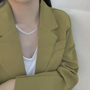 Close-up of S925 sterling silver pig nose chain necklace worn by a female model