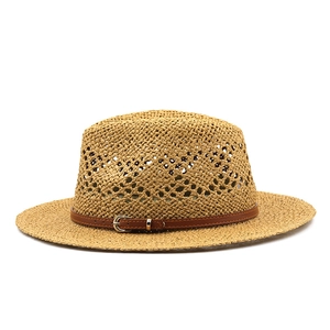 Close-up of hand-woven straw hat texture with breathable mesh and brown leather belt