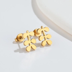 Detailed view of leaf-shaped gold stud earrings with polished finish and metal backings