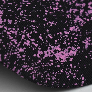 Macro shot of durable black twill fabric with vibrant purple starry sky print detailing