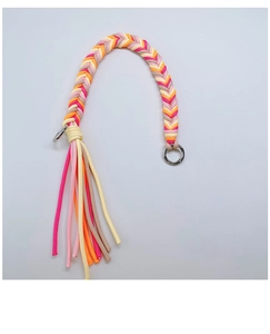 Detail of colorful herringbone braided strap with metal ring and fringe tassel