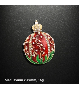 Detailed view of red enamel pomegranate brooch with crown top and size dimensions