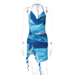 Detailed view of blue and white abstract print halter dress with ruffled hemline