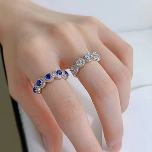 Detailed macro view of S925 sterling silver rings with blue and clear zircon gemstones