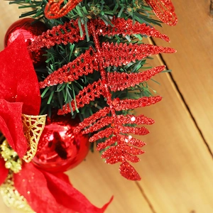 40cm Christmas wreath with red glitter leaves, baubles, and pine needles on wood