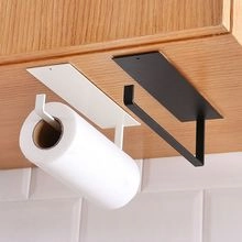 Detail showing white and black metal paper towel holders installed under a wooden cabinet