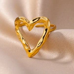 Detail of 18k gold plated stainless steel heart ring with hammered texture on silk
