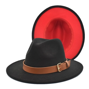 Detail of two-tone wool fedora hat featuring black exterior, red lining and leather strap