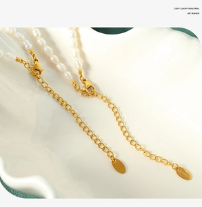 Detailed close-up of stainless steel extender chain and clasp with freshwater pearls