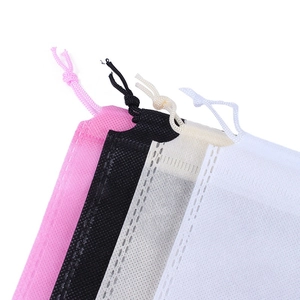 Non-woven drawstring storage bags in pink, black, beige, and white for dustproof shoe storage