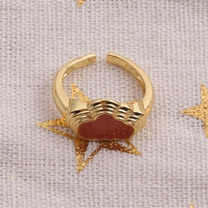 Detailed top view of gold-plated adjustable ring featuring red enamel cloud design