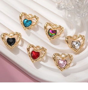 Detailed close-up of six heart-shaped alloy crystal charms on a white wavy pedestal