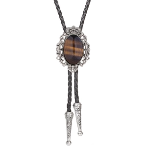 Detailed close-up of Western bolo tie with crown motif and brown tiger eye stone