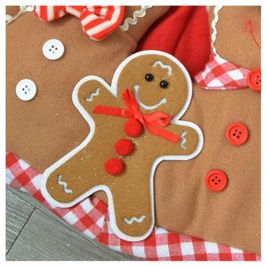 Detail of gingerbread man plush with red ribbon bow and white wavy edge embroidery