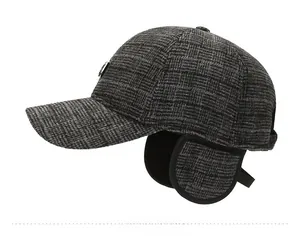 Side view of winter earflap baseball cap featuring dark grey plaid and metal detail