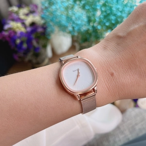 Elegant rose gold square quartz watch with woven mesh strap shown on a woman wrist