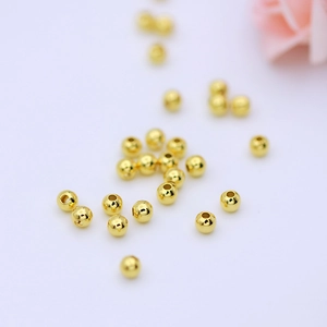 Macro detail of polished 14K gold-filled round beads for DIY jewelry making and crafts