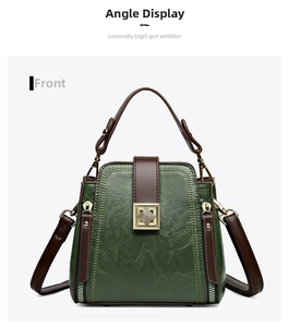 Front view of green leather bucket bag with brown handles and gold hardware detailing
