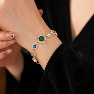 Luxury multi-color gemstone gold bracelet with emerald and sapphire accents in retro style