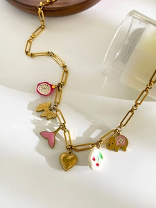 Detail view of gold paperclip chain necklace with colorful enamel elephant and heart charms