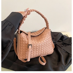 Detail of woven lotus pink handbag with premium checkered texture and crossbody strap