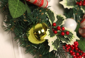 Detailed close-up of 50cm Christmas wreath with red berries, gold baubles and linen ribbon