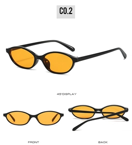 Detail view of retro oval sunglasses featuring black frames and vibrant orange lenses