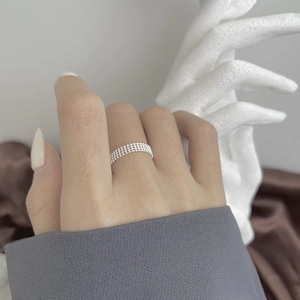 Close-up of s925 sterling silver four-layer bead ring worn on model finger
