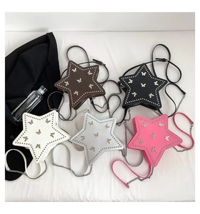 Flat lay of star-shaped crossbody bags with butterfly prints and rivet accents