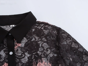 Close-up of black collar and pink lace texture on women shirt with size S label