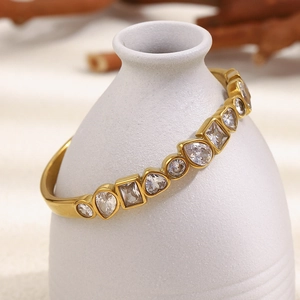 18K gold plated stainless steel bangle with mixed geometric cubic zirconia crystals