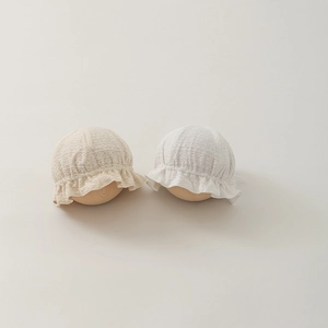 Detailed view of breathable lace cotton baby hats with delicate ruffled edges and texture