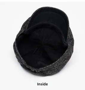 Detail view of the warm interior lining and stitching of the dark tweed newsboy cap