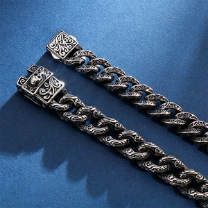 Vintage gothic men's stainless steel bracelet with skull charms and floral relief patterns