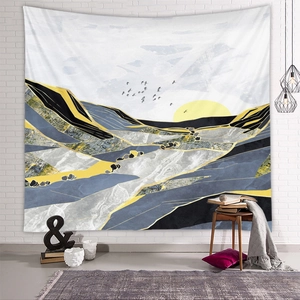 Detailed view of an abstract mountain tapestry on a white brick wall in a modern room