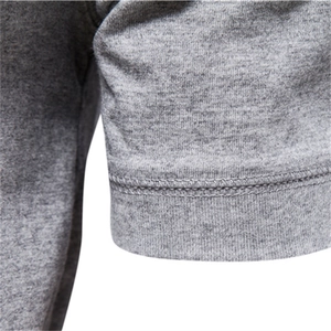 Detailed close-up of grey Henley cotton T-shirt showing sleeve stitching and knit texture