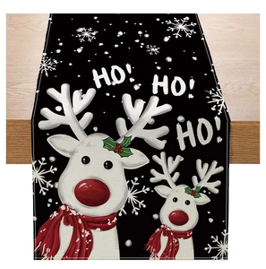Detail of Christmas table runner with reindeer motifs and HO HO HO text on linen fabric