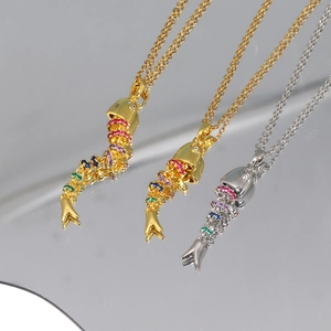 Detailed shot of jointed fish pendants with colorful stones and articulating bodies