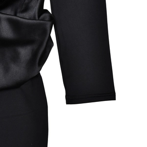 Detail of elegant black dress featuring satin and knit fabric texture contrast