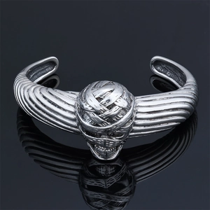 Macro shot of gothic mummy skull motif on vintage silver stainless steel cuff bracelet