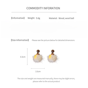 Detail view of round wood and fur ball earrings with 6.5cm length dimensions