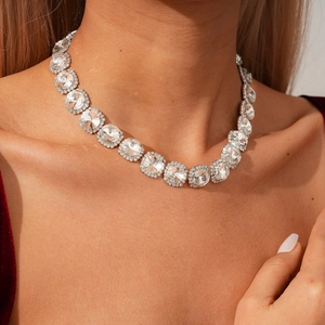Close-up of sparkling geometric diamond necklace with silver base on model neck
