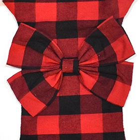 Detail of red and black buffalo plaid fabric bow with visible textile texture