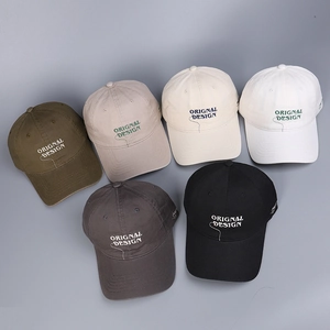 Detailed flat lay of cotton baseball caps in six colors with original design embroidery