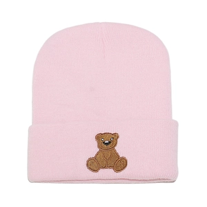Pink knit beanie for women featuring cute brown bear embroidery and ribbed texture