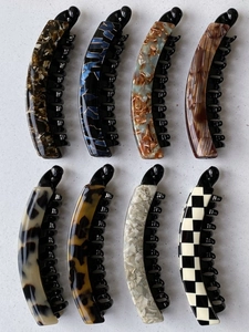 Close-up of assorted large banana clips with tortoiseshell and marble patterns