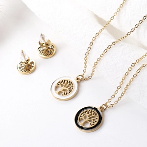 Detail of 18k gold plated tree of life jewelry set with white shell and black agate inlays